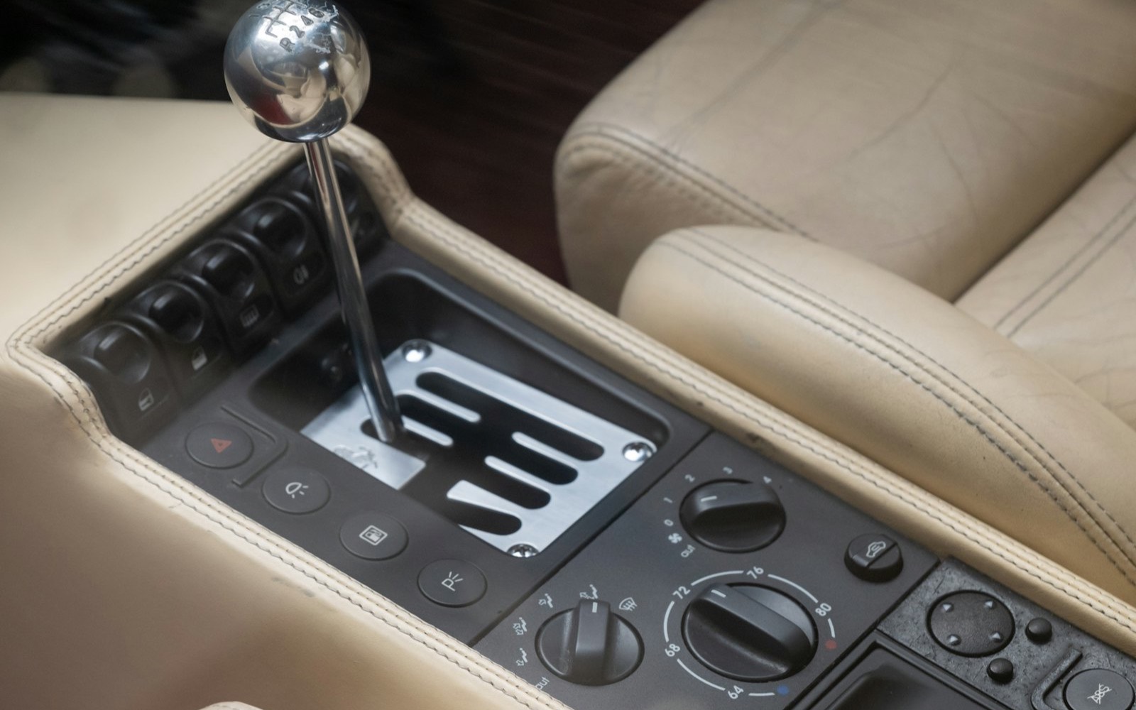 The gated metal shift gate of a vintage Ferrari manual transmission